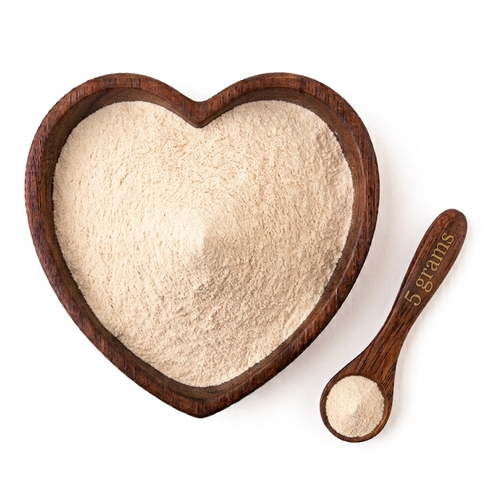 Heart-shaped wooden bowl filled with Organic Marine Sea Moss Powder and a 5-gram measuring spoon