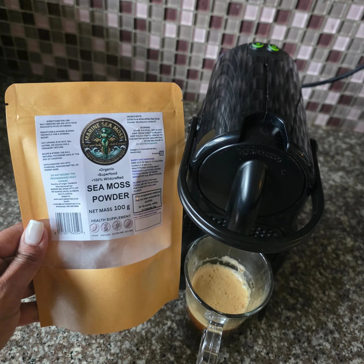 Sea Moss Powder added to coffee next to Nespresso machine