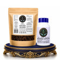 A Marine Sea Moss product bundle featuring a Raw Dried Sea Moss pouch and Sea Moss Capsules bottle displayed on a gold and blue pedestal against a white background