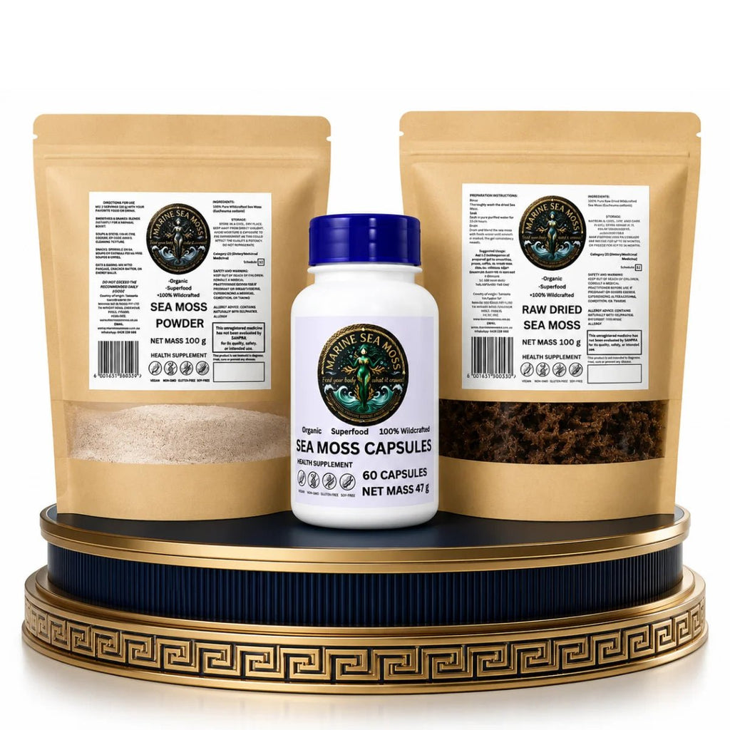 The Infinite Sea Moss Tier Bundle featuring a Marine Sea Moss Powder pouch, a Sea Moss Capsules bottle, and a Raw Dried Sea Moss pouch displayed on a decorative gold and blue pedestal