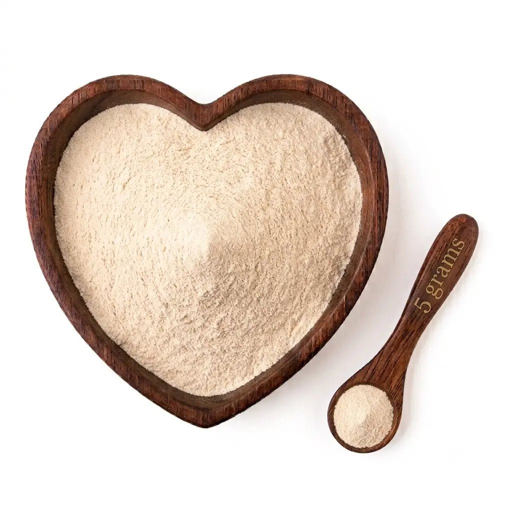 Heart-shaped wooden bowl filled with Marine Sea Moss Powder and a 5-gram measuring spoon