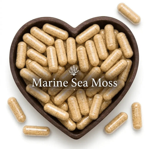 Heart-shaped bowl filled with Marine Sea Moss capsules on a white background